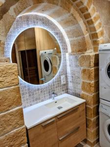 a bathroom with a sink and a mirror at La Pivoine in Sarlat-la-Canéda