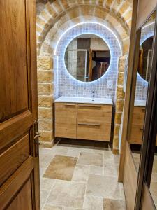 a bathroom with a sink and a mirror at La Pivoine in Sarlat-la-Canéda +15 photos