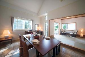 a living room with a table and a dining room at Resort Villa Takayama in Takayama