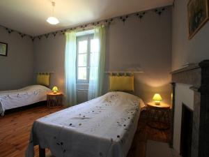a bedroom with two beds and a fireplace at Gîte Bournoncle-Saint-Pierre, 4 pièces, 6 personnes - FR-1-582-278 