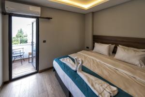a bedroom with a bed and a sliding glass door at Ferah Suites Hotel in Trabzon