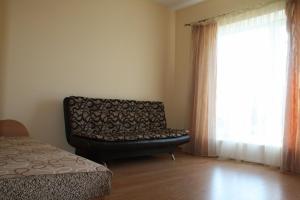 a living room with a couch and a window at Klaipedarent in Klaipėda