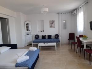 a room with a bed and a table and chairs at Magda house in Livadi