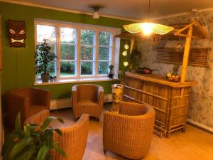 a room with chairs and a table and windows at Hotelli Verstas in Nakkila