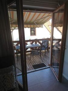 a view of a balcony with a table and chairs at Apartament z tarasem in Stegna