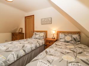 a bedroom with two beds and a staircase at Muskoka Lodge in Midsomer Norton