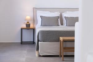 a bedroom with a bed and a table with a lamp at Archon Seaside Retreat in Plaka