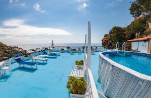 a resort with a swimming pool and the ocean at Le Terrazze sul mare in Ustica