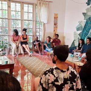 a group of people sitting in a room at BE ANIMAL Hostel in Bangalore