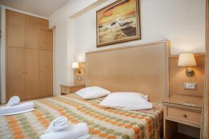 a hotel room with a bed with towels on it at Marietta Boutique Apts in Tsilivi