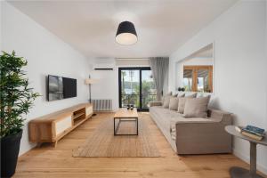 a living room with a couch and a tv at Yacht La Maison in Fethiye