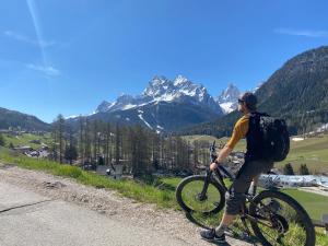 a man riding a bike on a mountain road at Unteradamerhof in Sesto
