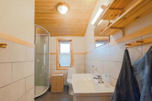 a bathroom with a sink and a shower at Guesthouse / Huskyfarm Innset in Innset