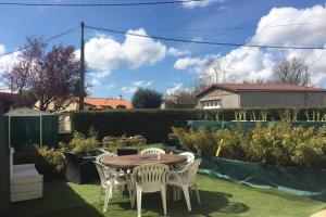 a wooden table and chairs in a garden at Magnifique maison 80m² avec extérieur in Saint-Michel-le-Cloucq