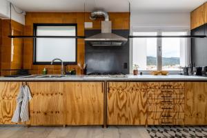 a kitchen with wooden cabinets and a sink at Casa Creu Mar in Sant Feliu de Guíxols