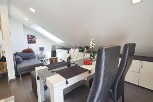 a kitchen and dining room with a table and chairs at Ferienwohnung Bodensee in Raderach in Friedrichshafen