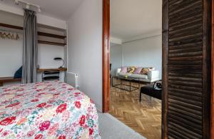a bedroom with a bed and a couch at Casa Creu Mar in Sant Feliu de Guíxols