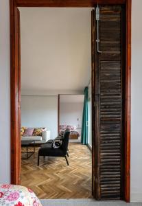 a view of a bedroom with a chair and a bed at Casa Creu Mar in Sant Feliu de Guíxols