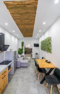 a kitchen and living room with a table and a couch at Vlychada's Diamond Apartments in Vlychada