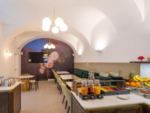a large kitchen with a table with food on it at Hotel Heritage in Ljubljana