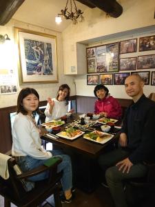 a group of people sitting around a table eating food at Live Cafe Hisui no Umi in Itoigawa