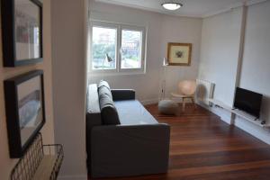 a living room with a couch and a television at Apartamento cerca de la playa in Santander