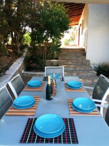 a table with blue plates and wine bottles on it at Sera de Vall in San Antonio Bay