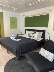 a bedroom with two beds and a couch at Hotelli Kaivo in Naantali
