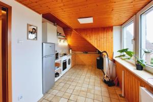 a kitchen with a white refrigerator and a wooden ceiling at Work & Stay Apartment mit TV & WLAN in Kleve