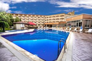 a swimming pool in front of a hotel at SIGNATURE GARDEN AVANOS Hotel & SPA in Avanos