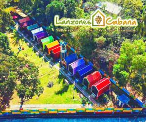 an overhead view of a colorful train on a track at Lanzones Cabana in Mambajao