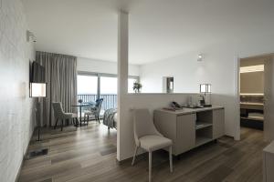 a room with a desk and a room with a table at Sublimis Boutique Hotel Adults-Only in Camogli