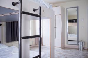 a bedroom with a bunk bed and a mirror at Oberstdorf Hostel in Oberstdorf