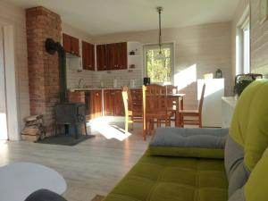 a living room with a couch and a kitchen with a stove at Orle in Orle