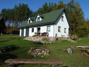 a large white house with a green roof at Orle in Orle