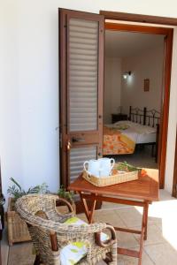 a room with a table and a room with a bed at B&B Minerva in Castro di Lecce +19 photos