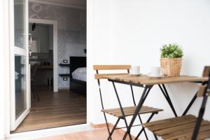 a living room with a table and a bedroom at Le Camere di Giò in Ameglia