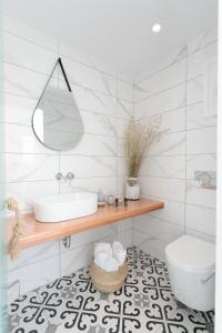 a bathroom with a sink and a toilet at Iades Studios & Apartments in Agia Anna Naxos