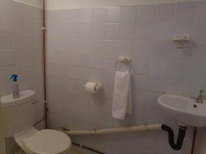 a bathroom with a toilet and a sink at Fishermans Cottage - BillsBest in Port Edward