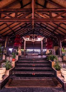 Nugraha Lovina Seaview Resort & Spa في لوفينا: مجموعة من السلالم في مبنى يحتوي على نباتات الفخار