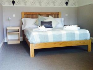 a bedroom with a bed with two bowls on it at The Charlton Inn in Blandford Forum +1 photo