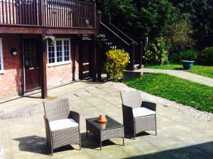 un grupo de sillas y una mesa en un patio en The Charlton Inn en Blandford Forum