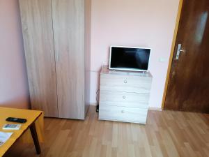 a living room with a tv on top of a dresser at Stai Za Gosti Venera in Hisarya