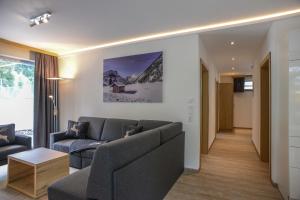 a living room with a couch and a table at R Appartements in Tannheim