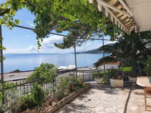 a patio with a view of the water at Apartments Jerković Drašnice-2bd in Drašnice