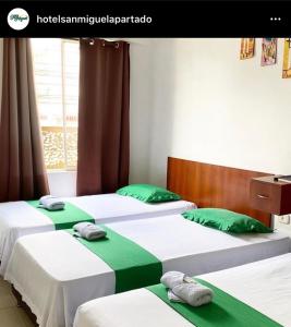 Postel nebo postele na pokoji v ubytování Hotel San Miguel Apartadó