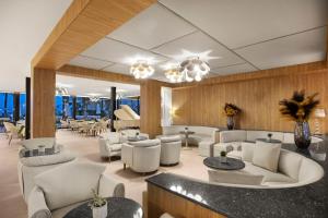 a lobby with couches and tables and chairs at VIVA Golf Adults Only 18+ in Port d'Alcudia