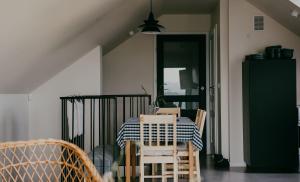 a dining room with a table and chairs and a door at Apartament Sielanka in Międzybrodzie Bialskie