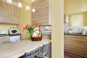 a kitchen with a counter with a basket of oranges at Elite Apartments Sopot Superior in Sopot