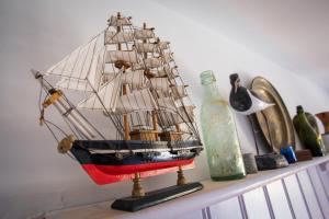 a model of a ship sitting on top of a shelf at The Smugglers Inn in Weymouth